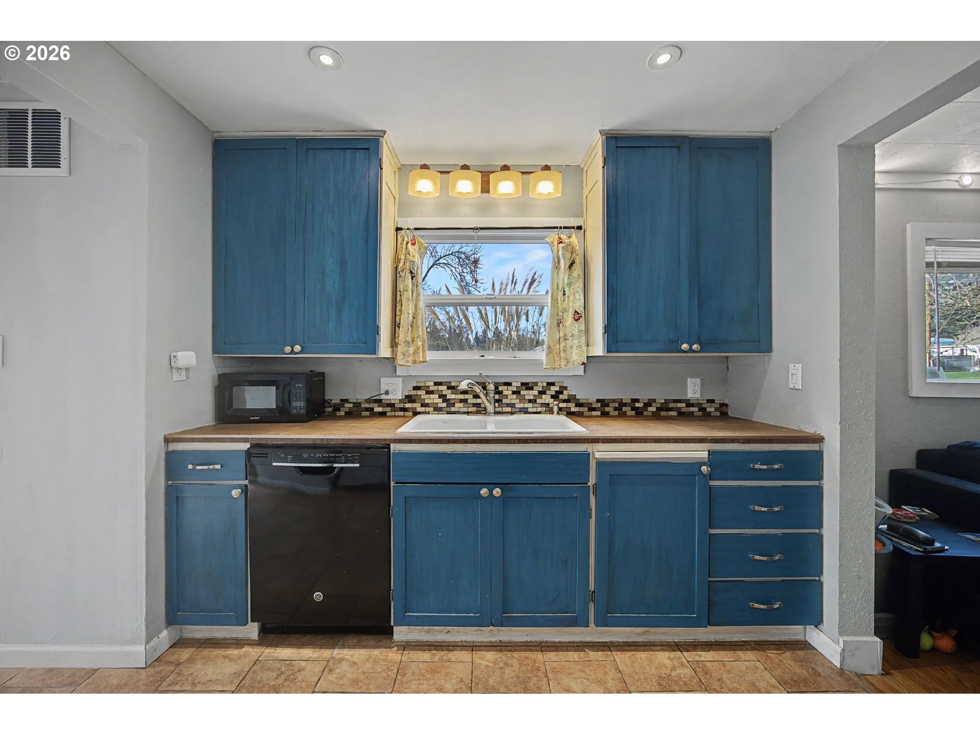 7808 Southeast Roots Road Milwaukie, OR 97267 - Photo 13 of 13 a kitchen with a sink and cabinets