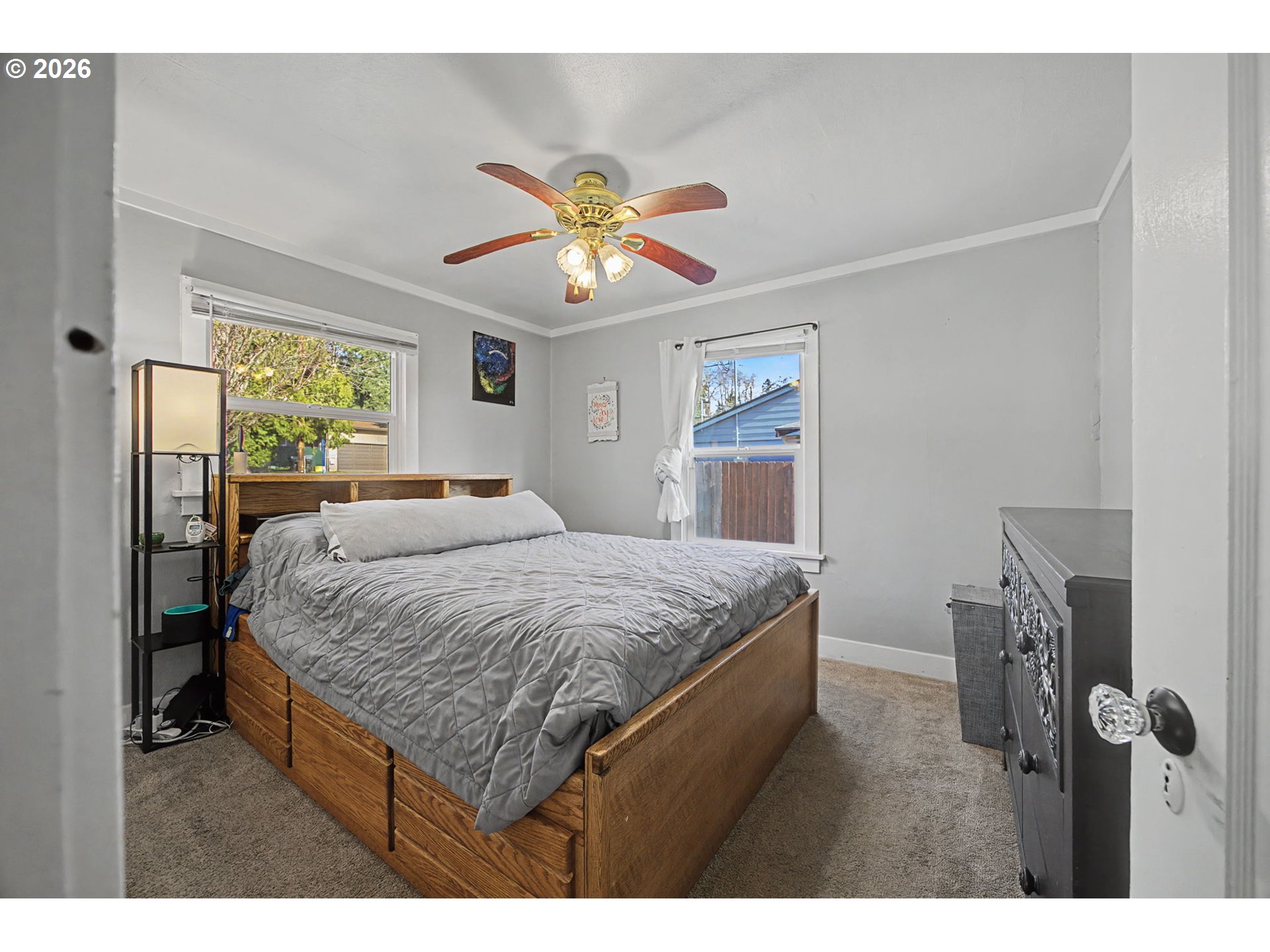 7808 Southeast Roots Road Milwaukie, OR 97267 - Photo 2 of 13 a bedroom with a bed and a chandelier