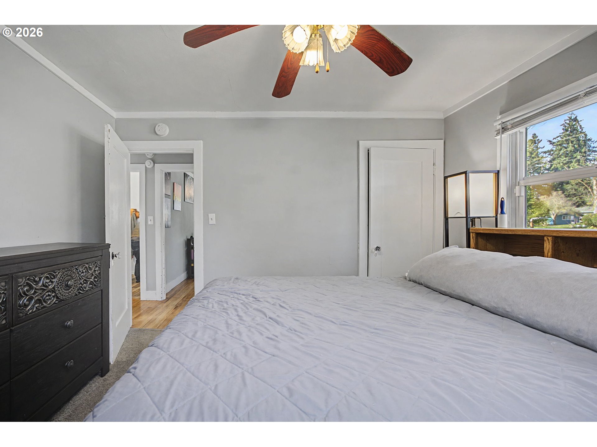 7808 Southeast Roots Road Milwaukie, OR 97267 - Photo 3 of 13 a bedroom with a bed and a walk in closet