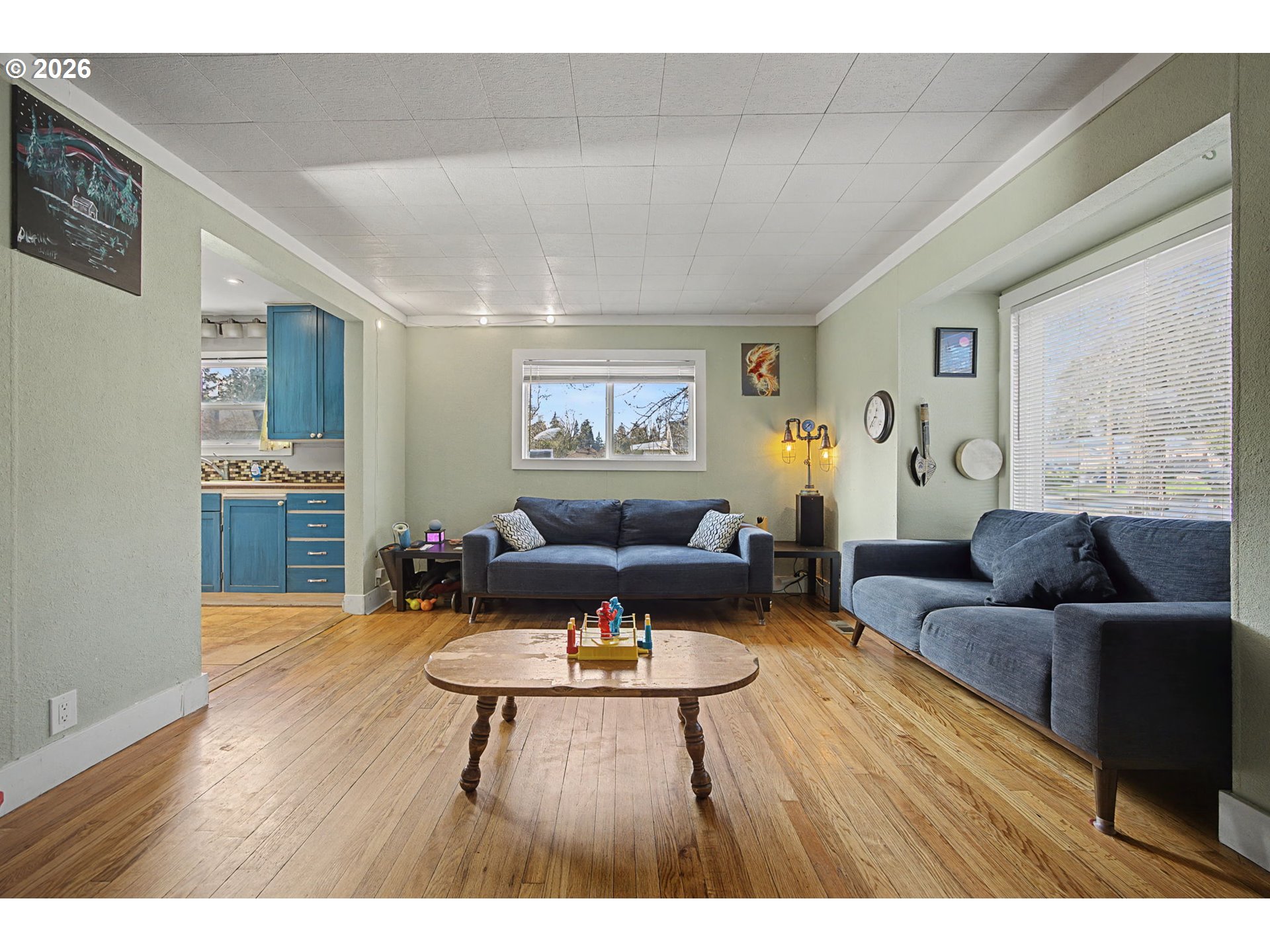 7808 Southeast Roots Road Milwaukie, OR 97267 - Photo 10 of 13 a living room with furniture and a wooden floor