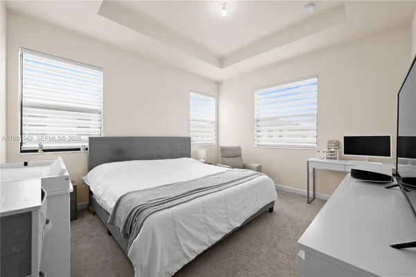 a bedroom with a bed and a desk