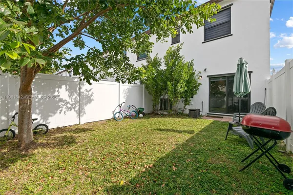 a backyard of a house with table and chairs