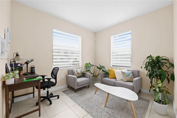 a living room with furniture and a potted plant