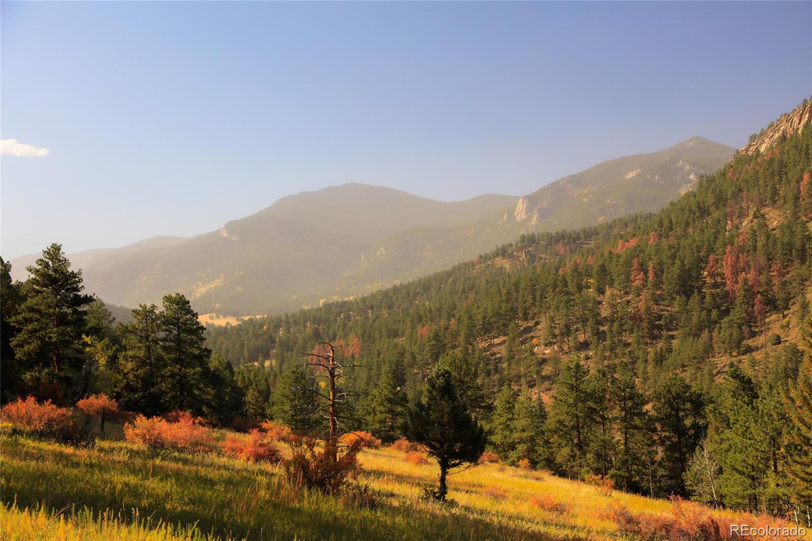 Upper Bear Creek Road Evergreen, CO 80439 - Photo 23 of 31 a view of a town with mountains in the background