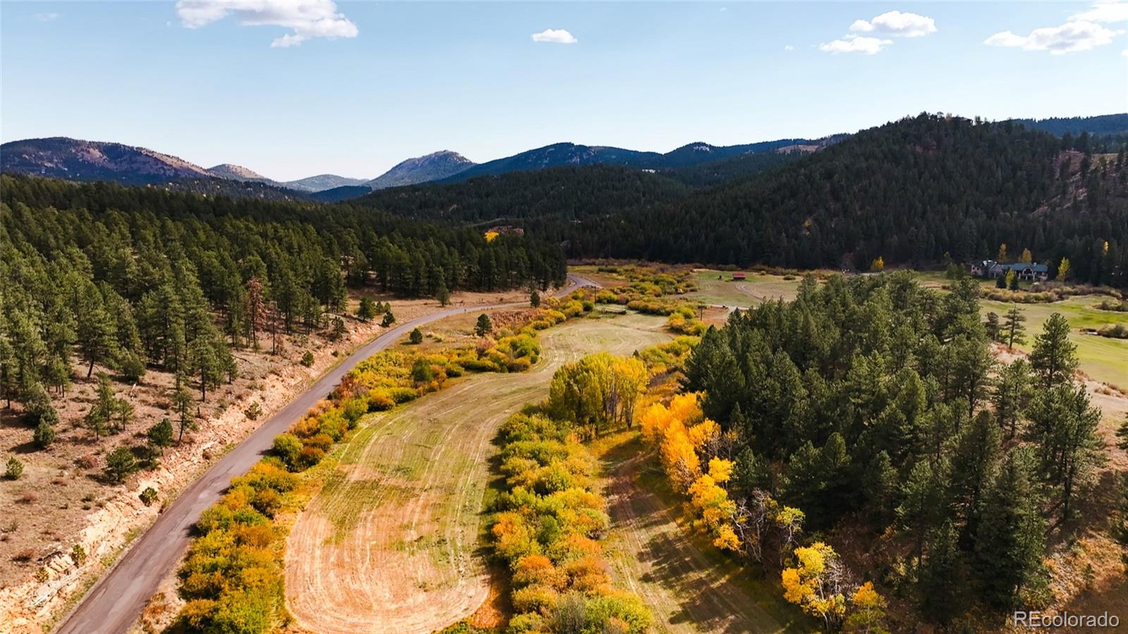 Upper Bear Creek Road Evergreen, CO 80439 - Photo 25 of 31 a view of a house with a mountain