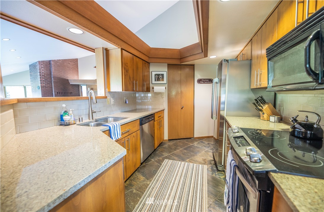 36815 Mann Road Sultan, WA 98294 - Photo 11 of 38 a kitchen with stainless steel appliances granite countertop a sink stove and refrigerator