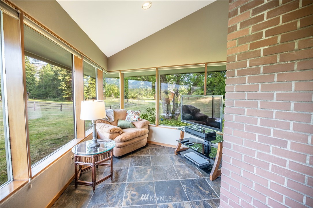 36815 Mann Road Sultan, WA 98294 - Photo 8 of 38 a living room with patio furniture and floor to ceiling windows