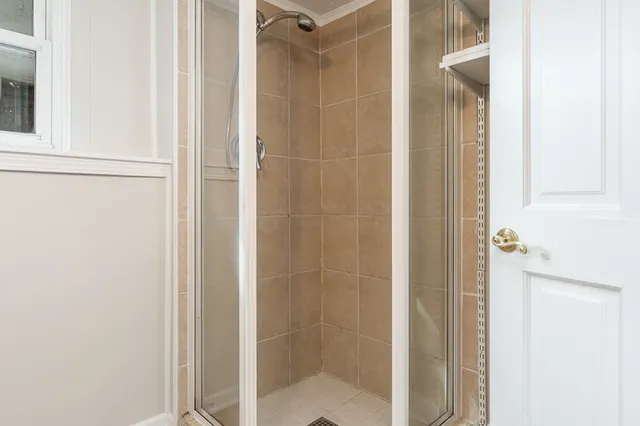 a bathroom with a glass shower door
