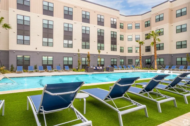 a swimming pool with outdoor seating and yard
