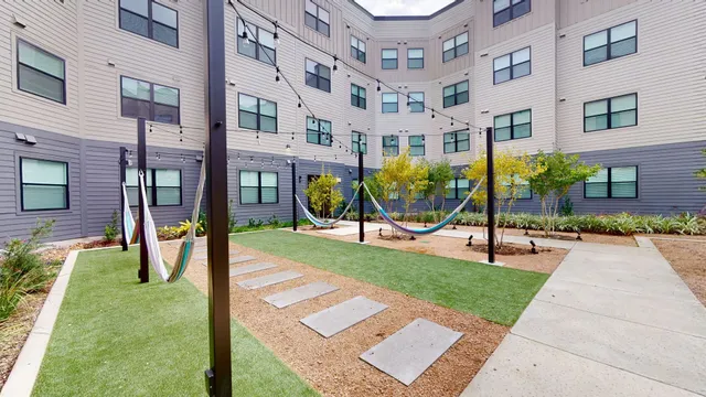 a view of a building with a yard