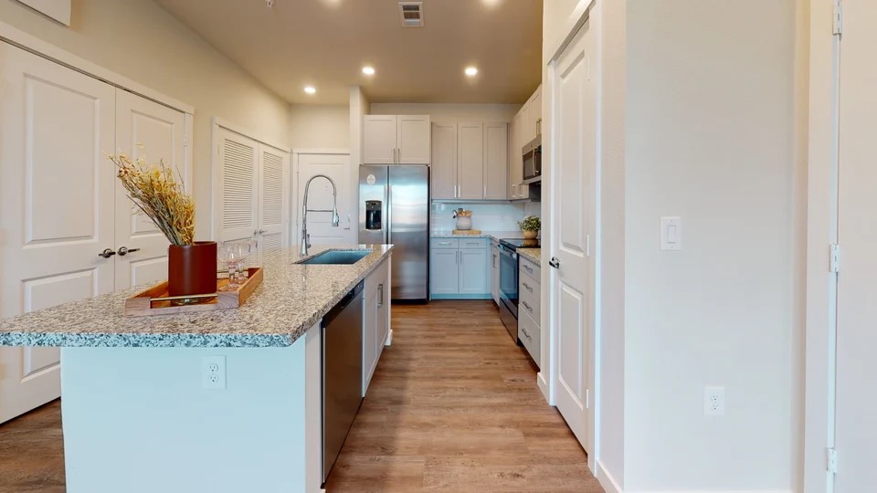 1148 Silber Road, Unit 8301 Houston, TX 77055 - Photo 3 of 36 a kitchen with kitchen island granite countertop a sink and wooden cabinets