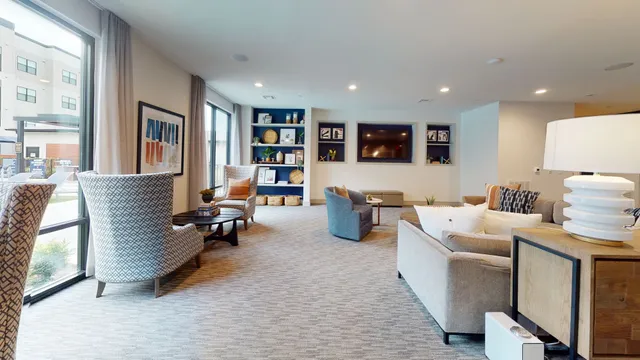 a living room with furniture gym equipment and a large window