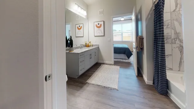 a hall way with wooden floor and furniture