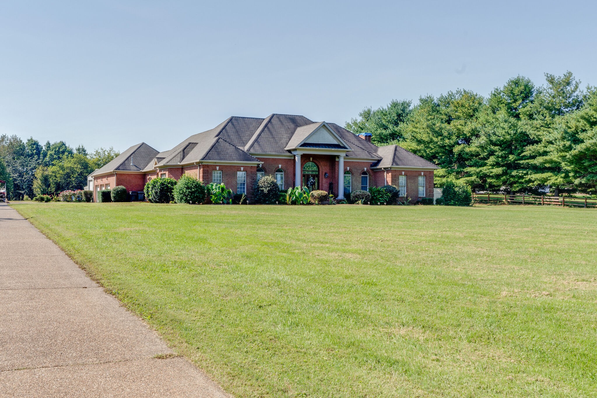 404 Denning Ford Road Portland, TN 37148 - Photo 2 of 30 a house that has a big yard with plants and palm trees
