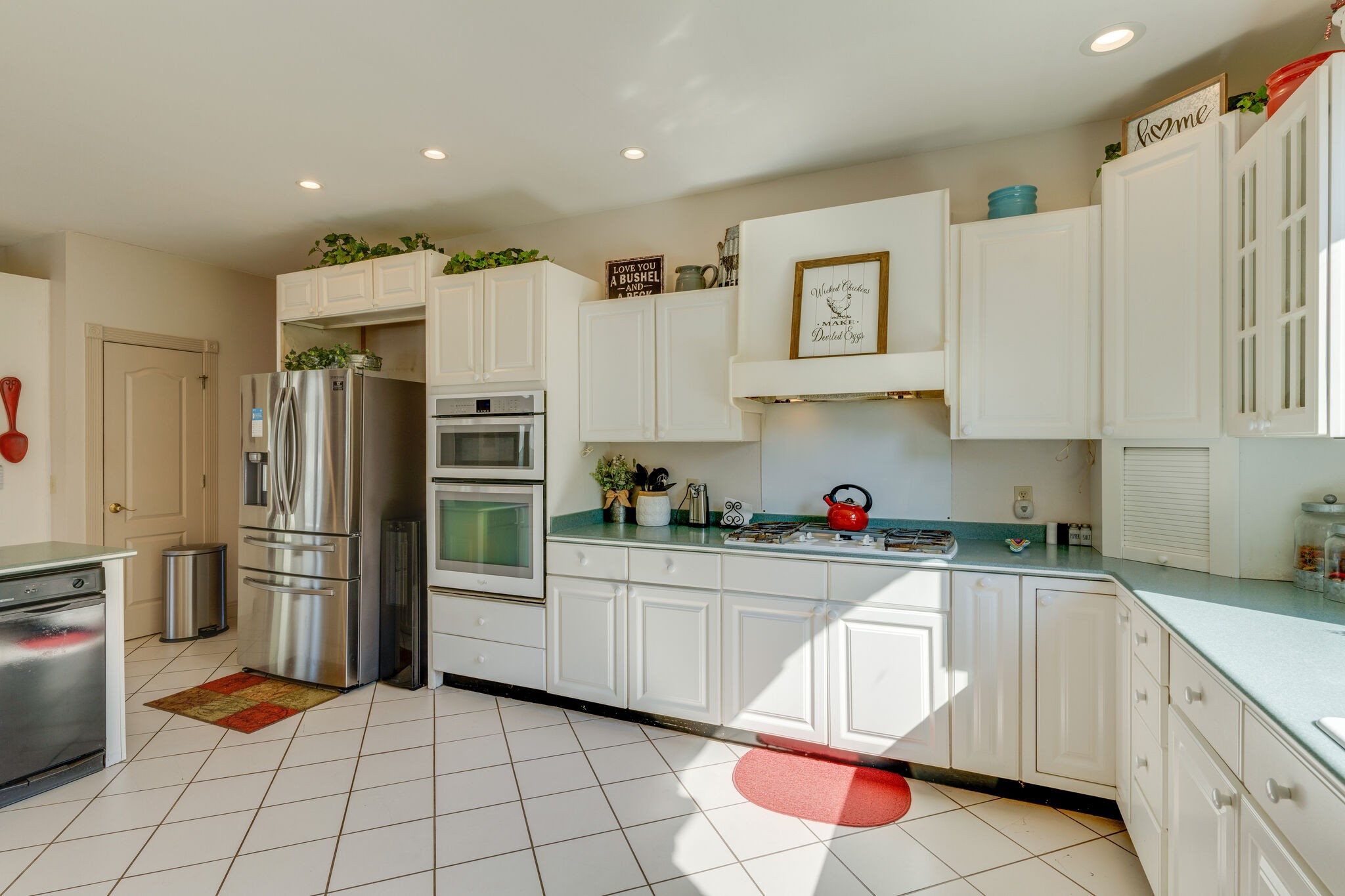 404 Denning Ford Road Portland, TN 37148 - Photo 14 of 30 a kitchen with white cabinets and stainless steel appliances