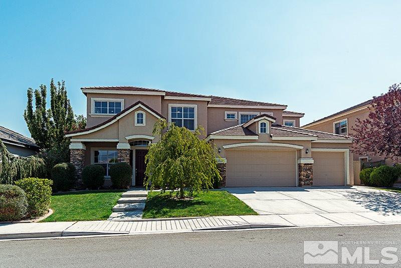 10160 Canyon Country Road Reno, NV 89521 - Photo 1 of 1 a front view of a house with a yard and garage