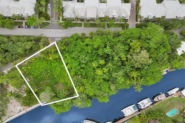 an aerial view of a residential houses with outdoor space and street view