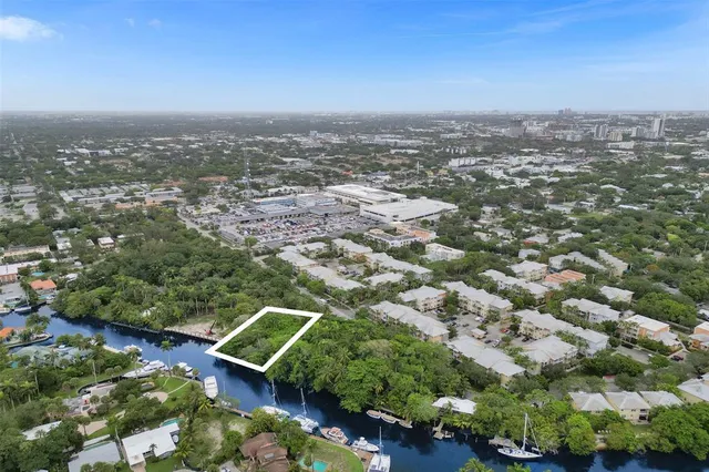 an aerial view of a residential houses with city view