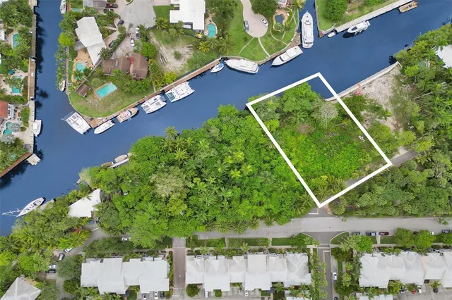 an aerial view of a tennis ground and a yard
