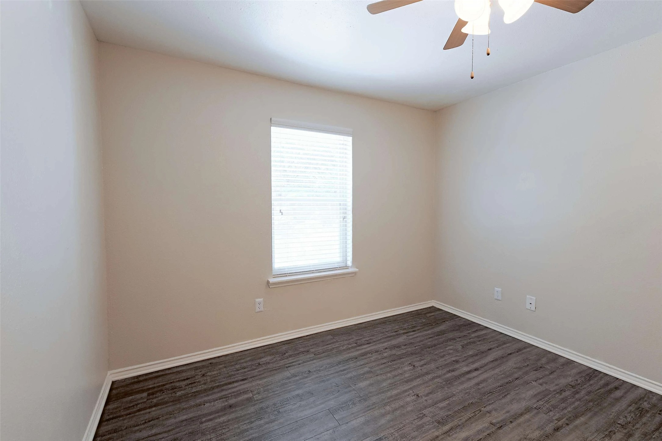 2809 West William Cannon Drive, Unit I101 Austin, TX 78745 - Photo 11 of 29 Spare room featuring dark wood-style floors and a ceiling fan