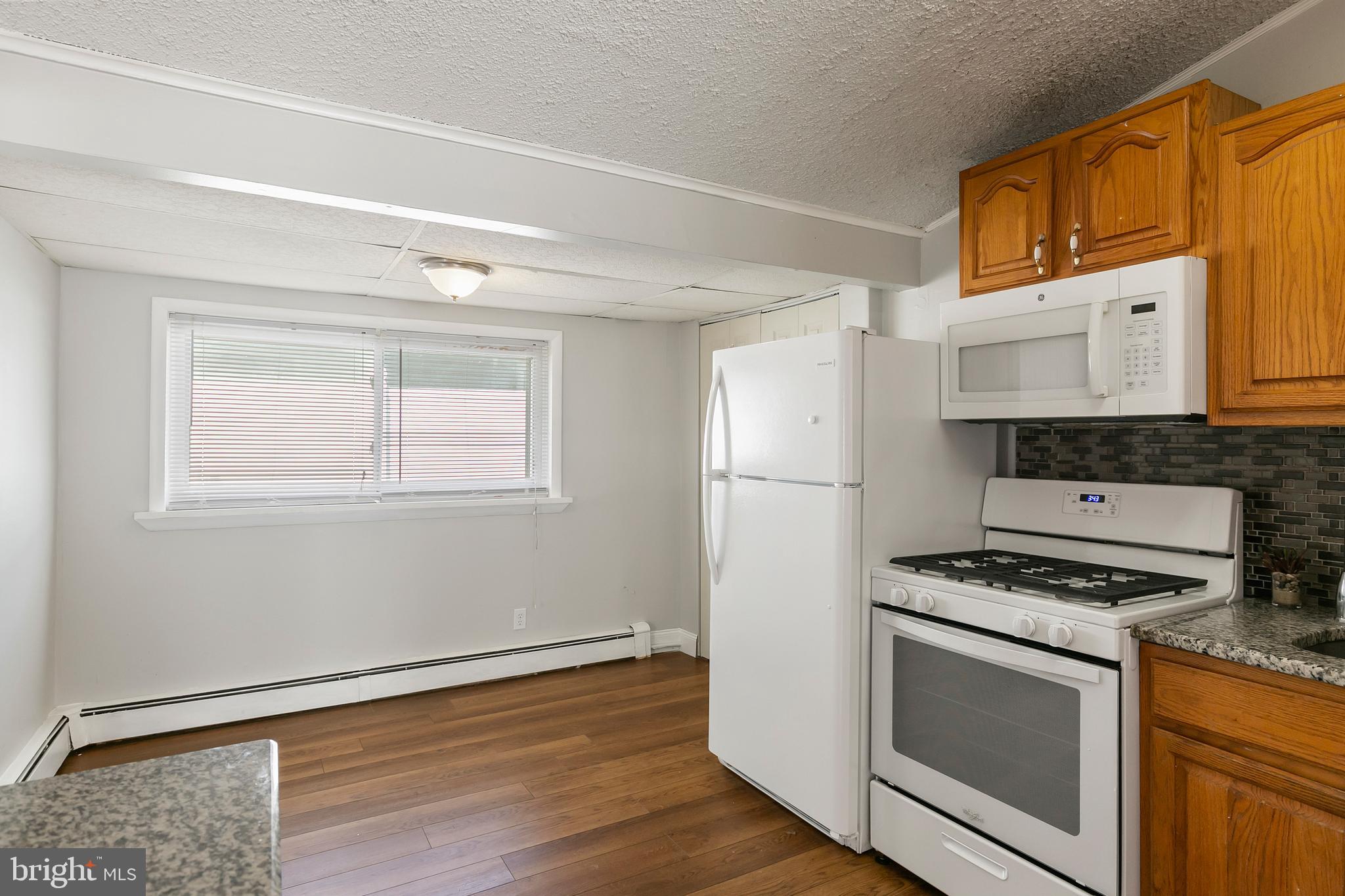 523 Estate Road Maple Shade, NJ 08052 - Photo 11 of 30 a kitchen with granite countertop a stove a sink dishwasher and a refrigerator with wooden floor