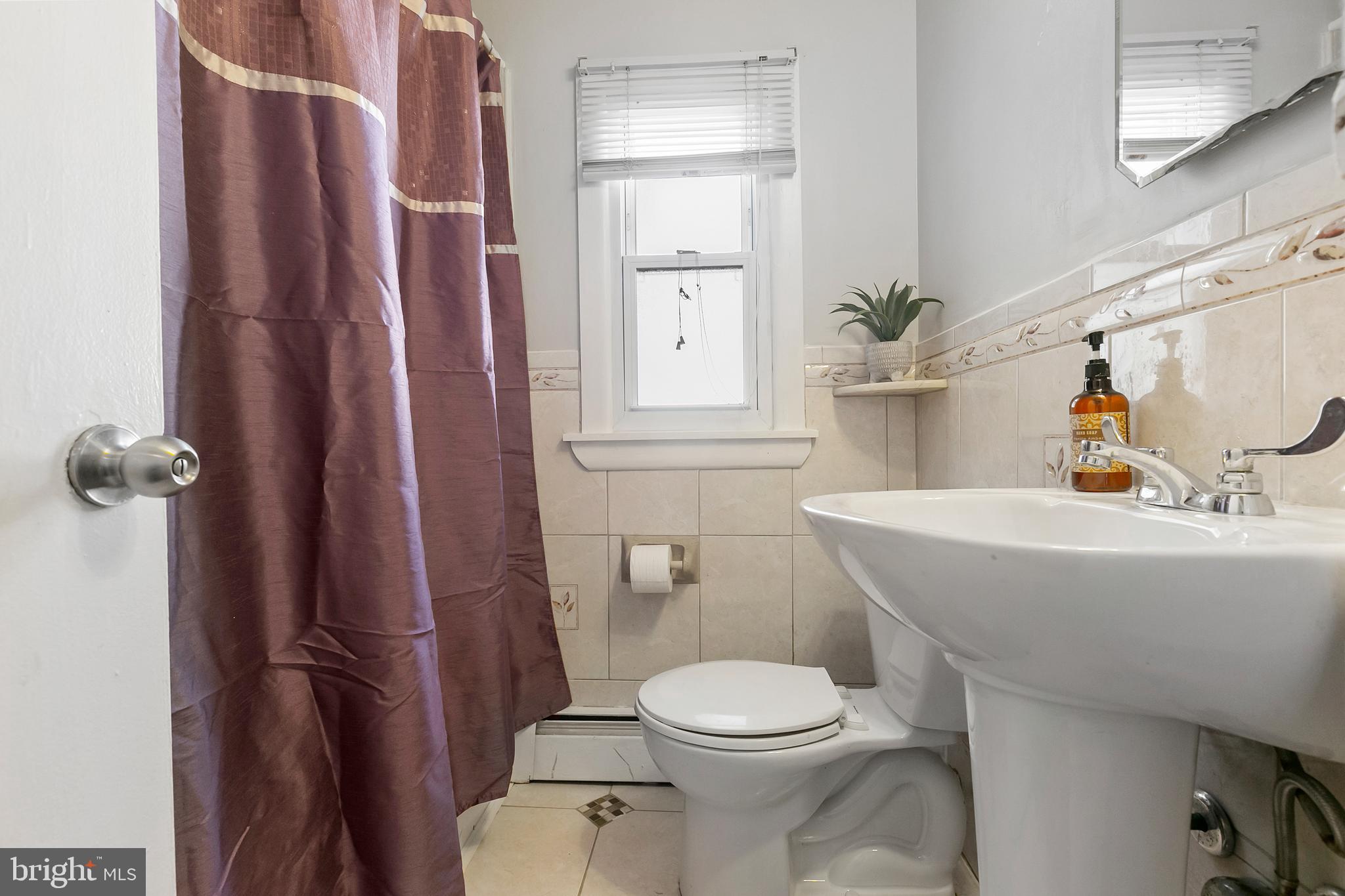 523 Estate Road Maple Shade, NJ 08052 - Photo 19 of 30 a bathroom with a sink a toilet and shower curtain