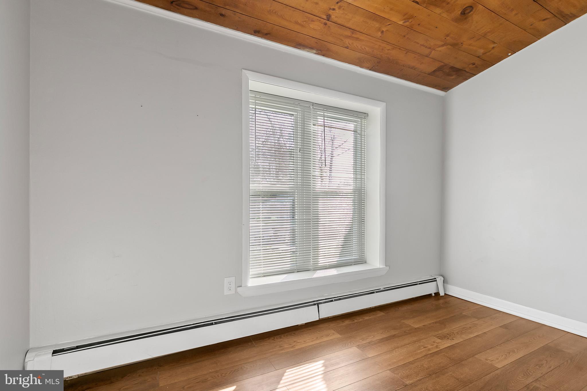 523 Estate Road Maple Shade, NJ 08052 - Photo 26 of 30 a view of an empty room with wooden floor and a window
