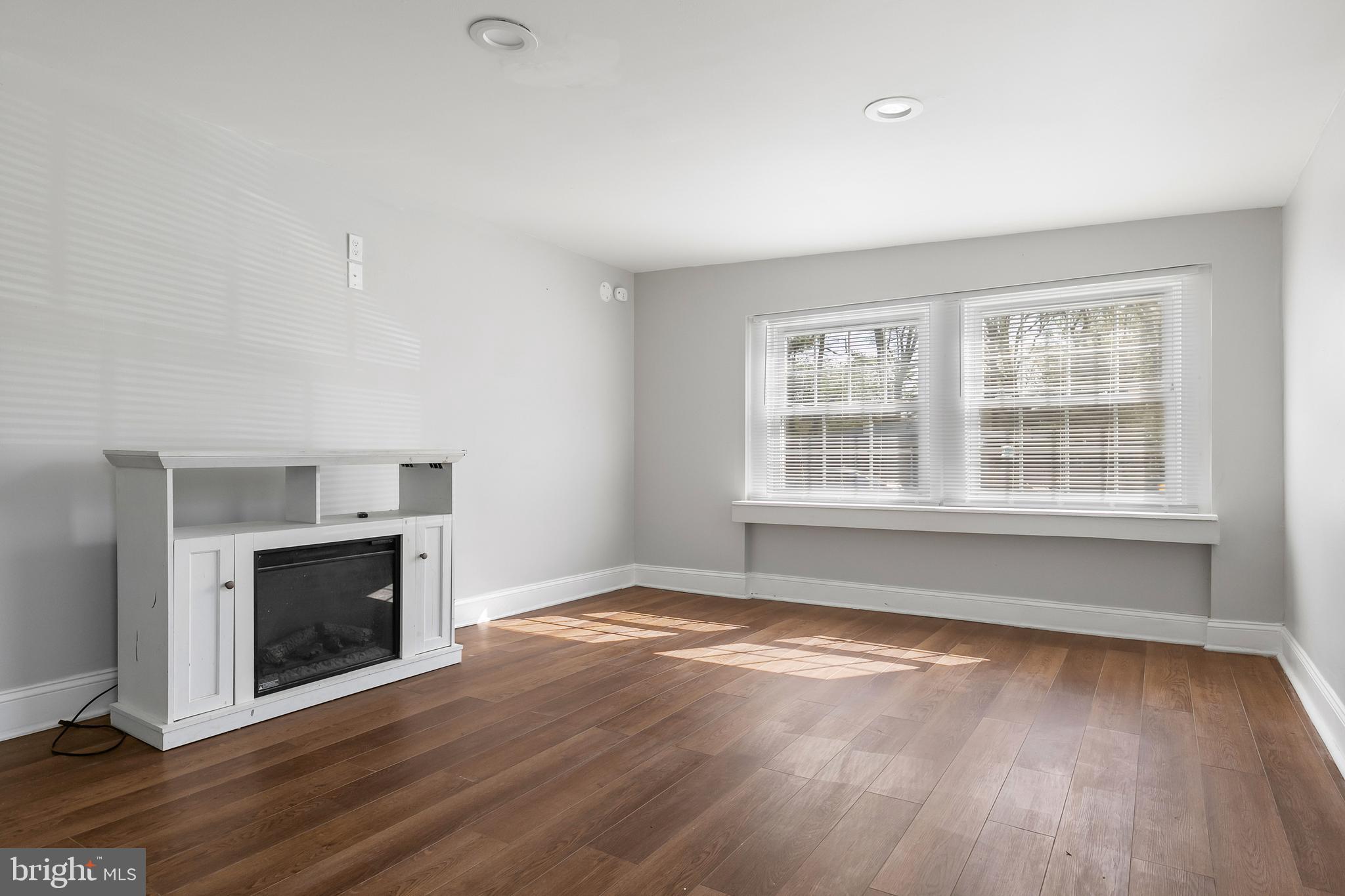 523 Estate Road Maple Shade, NJ 08052 - Photo 4 of 30 wooden floor fireplace and windows in an empty room
