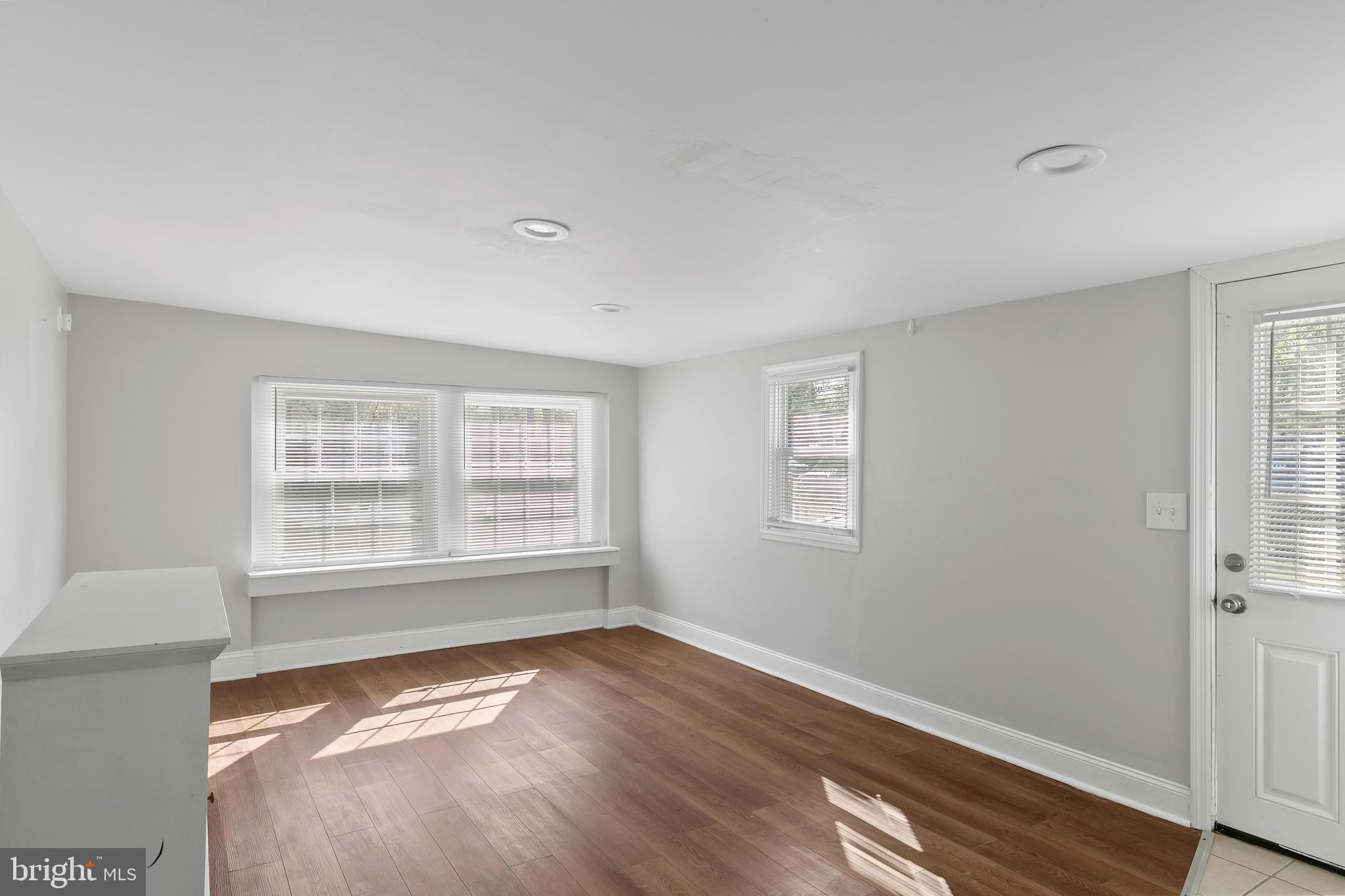523 Estate Road Maple Shade, NJ 08052 - Photo 7 of 30 a view of an empty room with wooden floor and a window