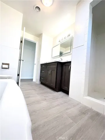 a bedroom with a bed and cabinets