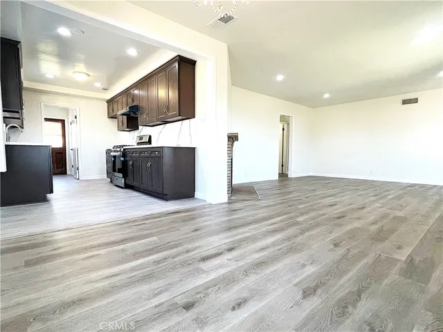 a view of living room with kitchen island furniture and a flat screen tv