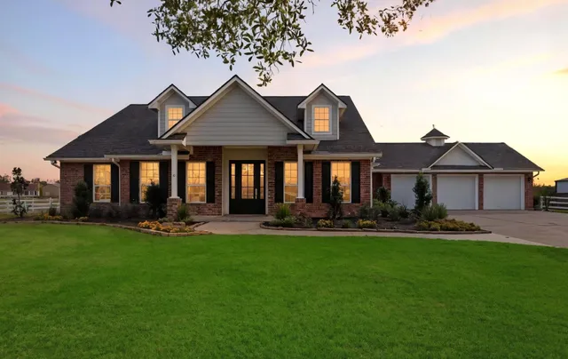 a front view of a house with swimming pool and yard