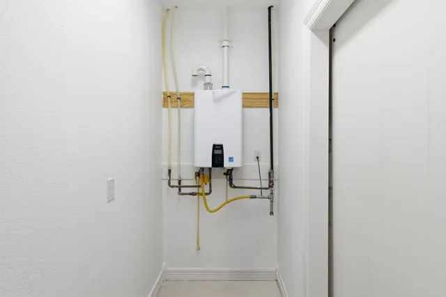 a front view of a house with a garden and trees