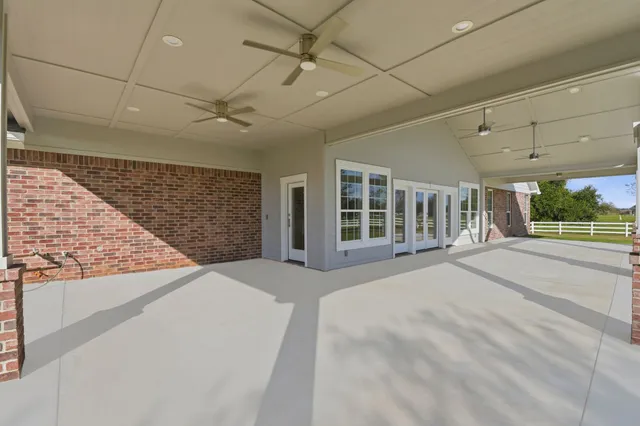 a view of a house with a backyard porch and sitting area