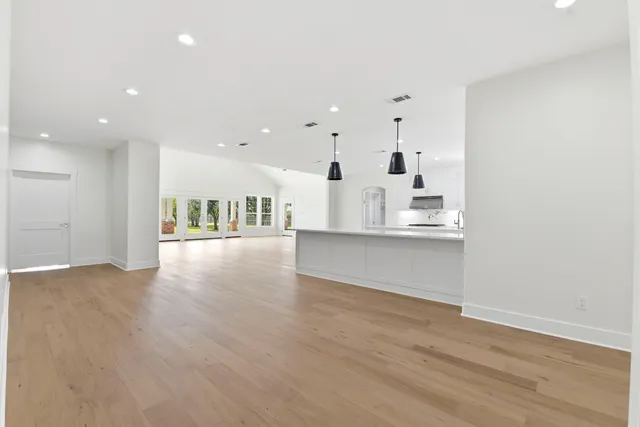 a view of kitchen with kitchen island and stainless steel appliances