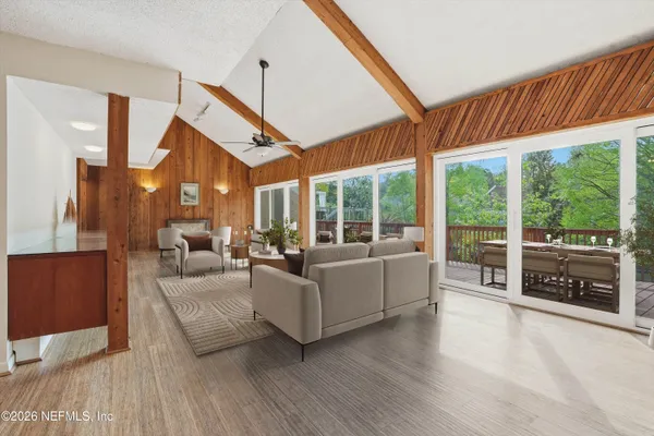 a bedroom with a bed and glass walk in closet