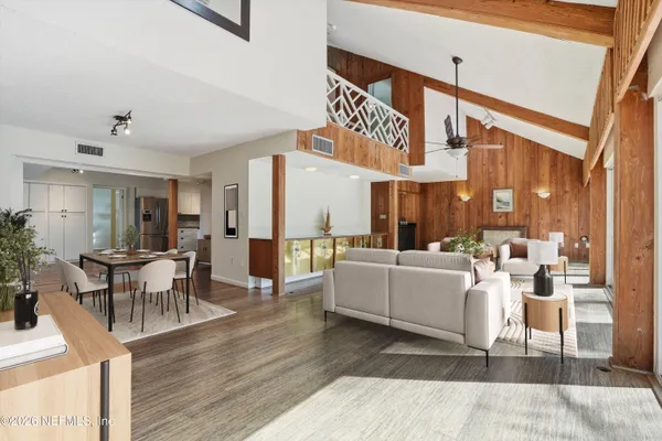 a living room with furniture a large window with outer view