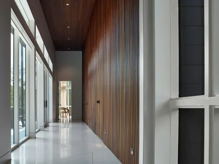 a view of a hallway with wooden floor and staircase