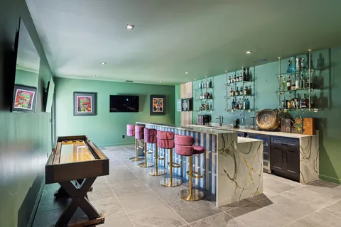 a room with pool table and a chandelier