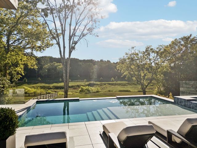 a patio with patio couch and outdoor view