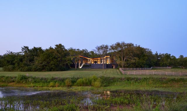 a view of a house with backyard sitting area and garden