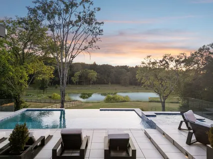 a view of yard with seating area and trees around