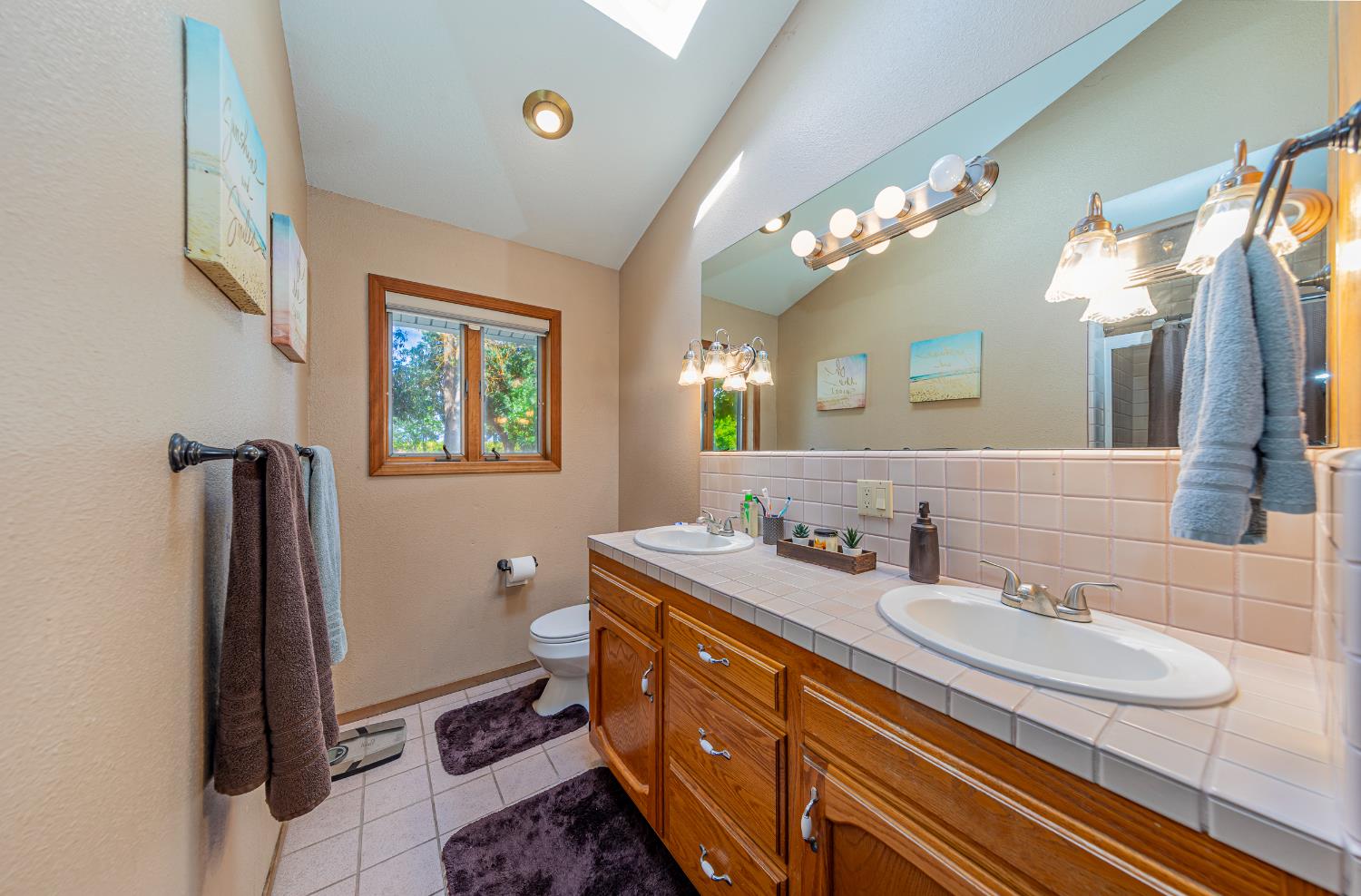 4449 Stetson Road Clovis, CA 93619 - Photo 40 of 93 a bathroom with a double vanity sink and a mirror