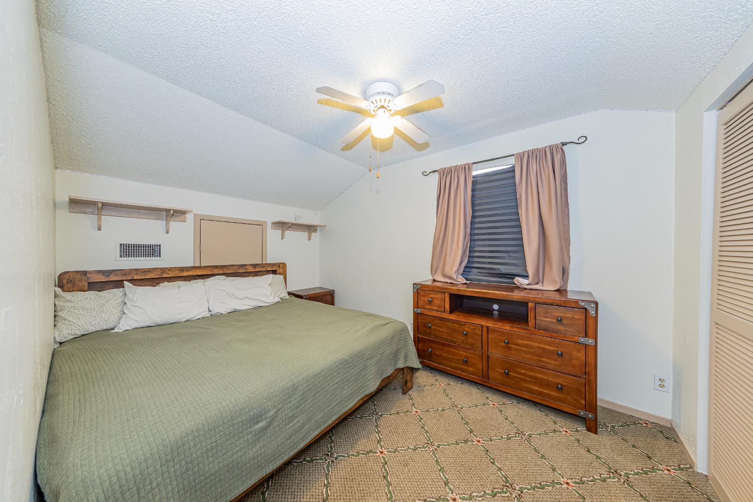 4449 Stetson Road Clovis, CA 93619 - Photo 61 of 93 a bedroom with a bed and a chandelier