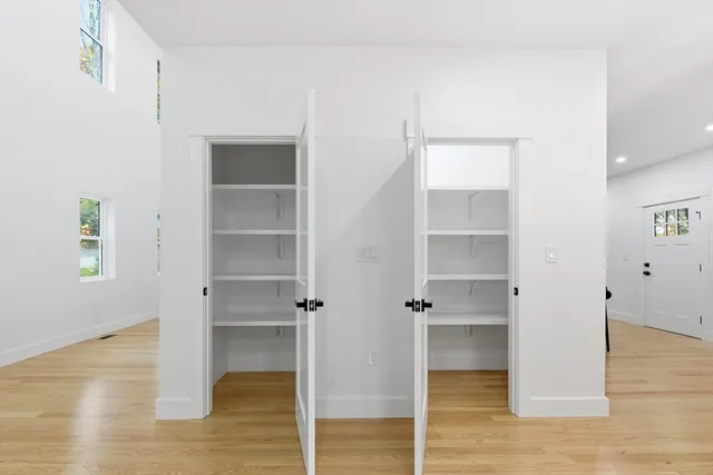 a view of walk in closet with empty racks