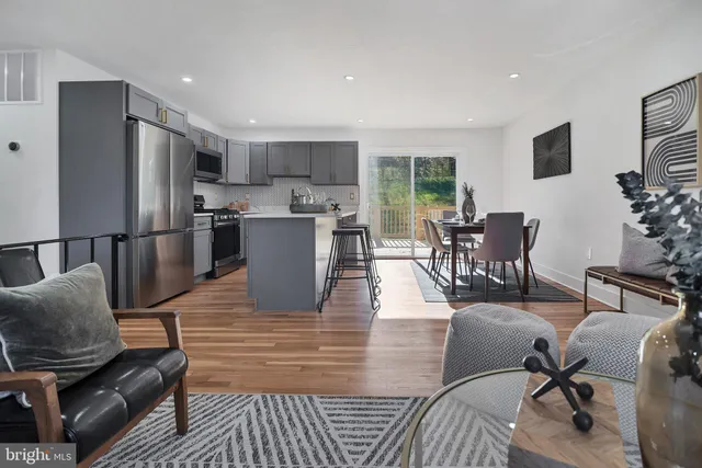 a living room with furniture wooden floor and a flat screen tv