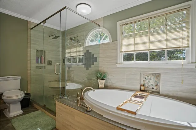 a bathroom with a sink a toilet and a shower