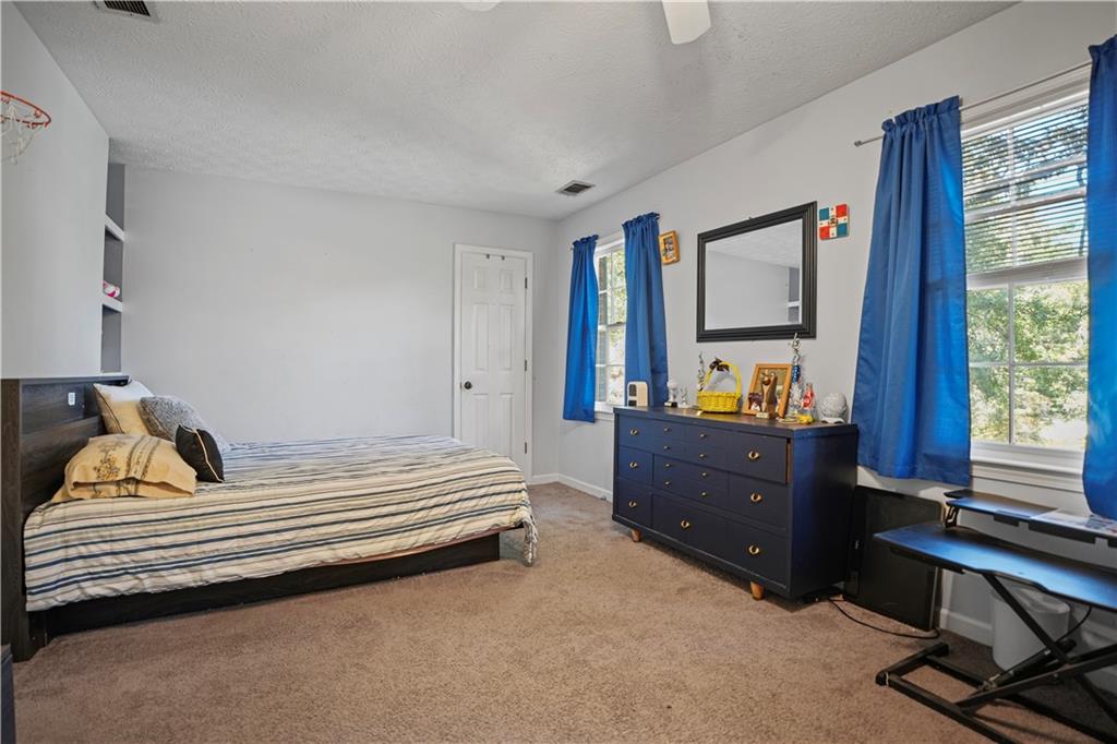 4880 Racquet Court Duluth, GA 30096 - Photo 11 of 22 a bedroom with a bed and a window