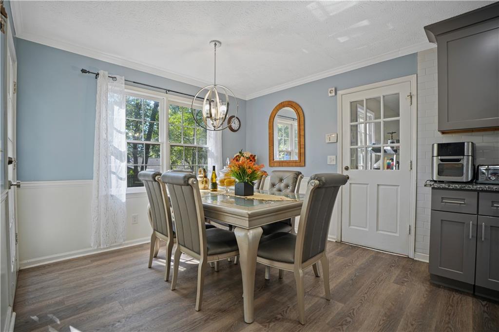 4880 Racquet Court Duluth, GA 30096 - Photo 12 of 22 a dining room with furniture a chandelier and wooden floor