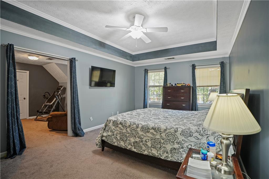 4880 Racquet Court Duluth, GA 30096 - Photo 14 of 22 a bedroom with a bed and a walk in closet